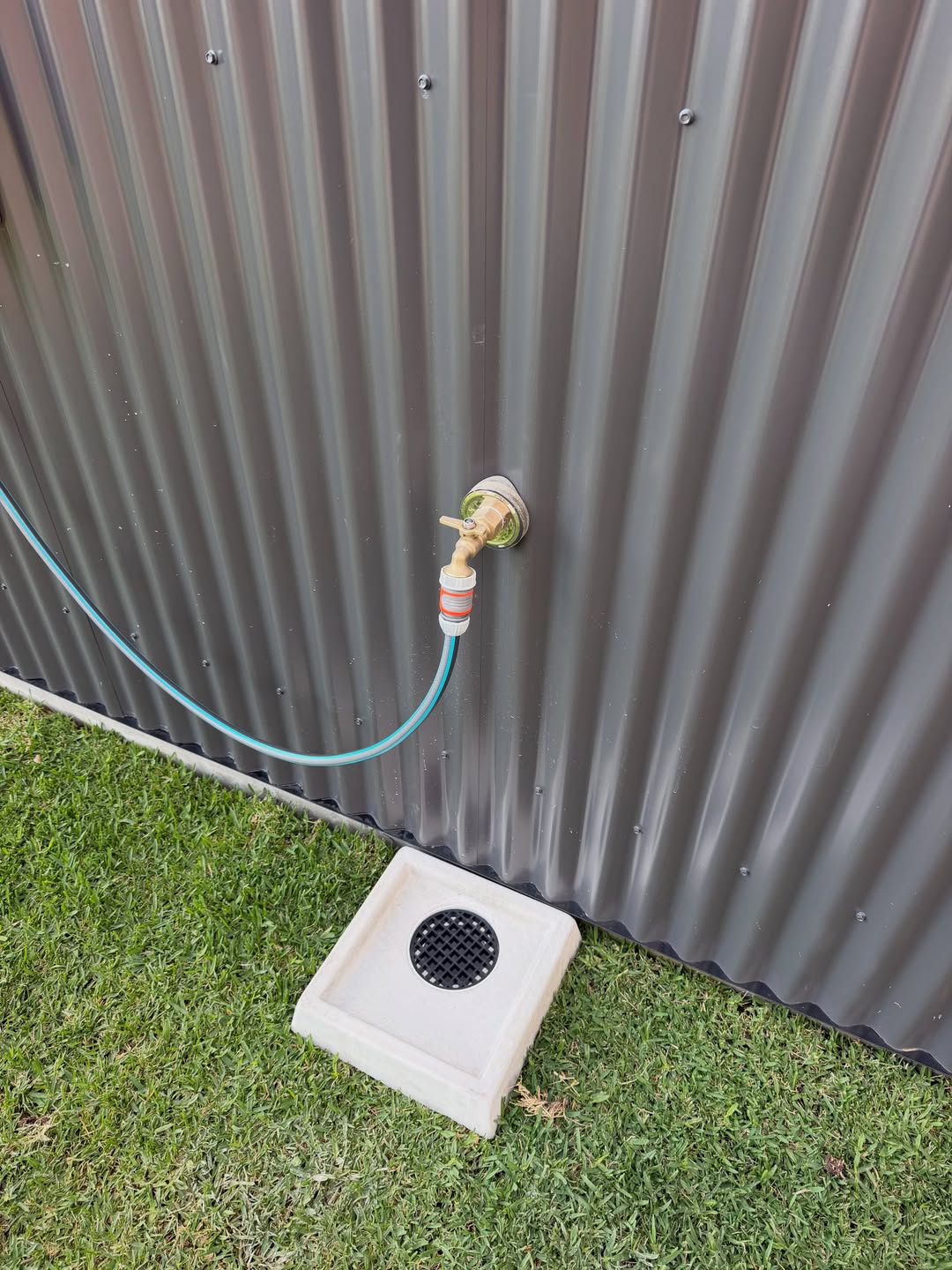 Outdoor tap outlet on the commercial shed exterior wall